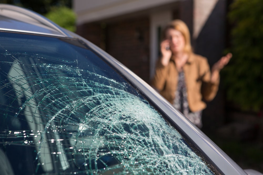 woman phoning help after car windshield - Why Mobile Auto Glass Repair is a Game-Changer