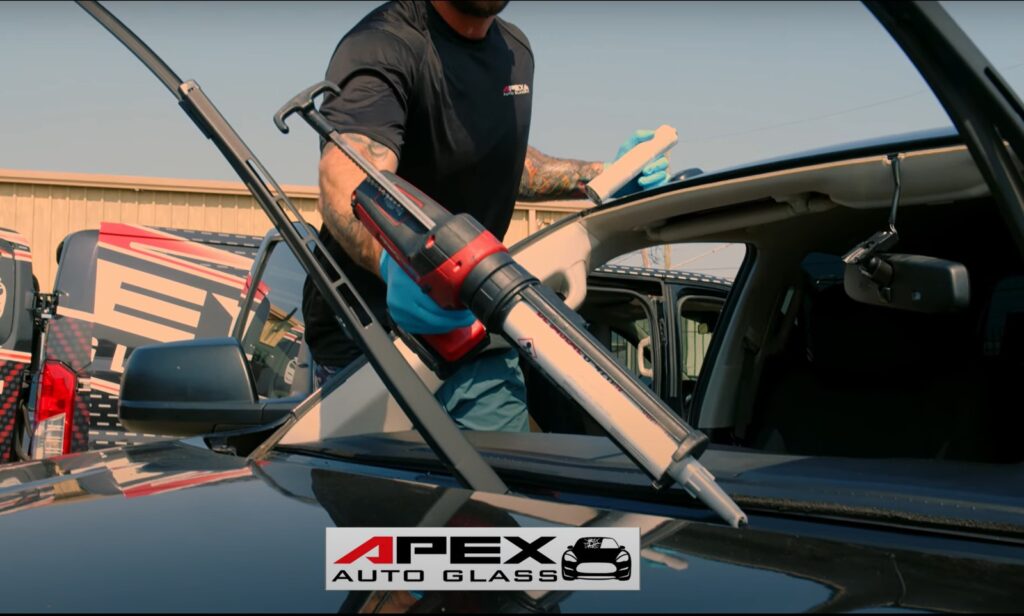 apex auto glass working on a windshield repair in new orleans.