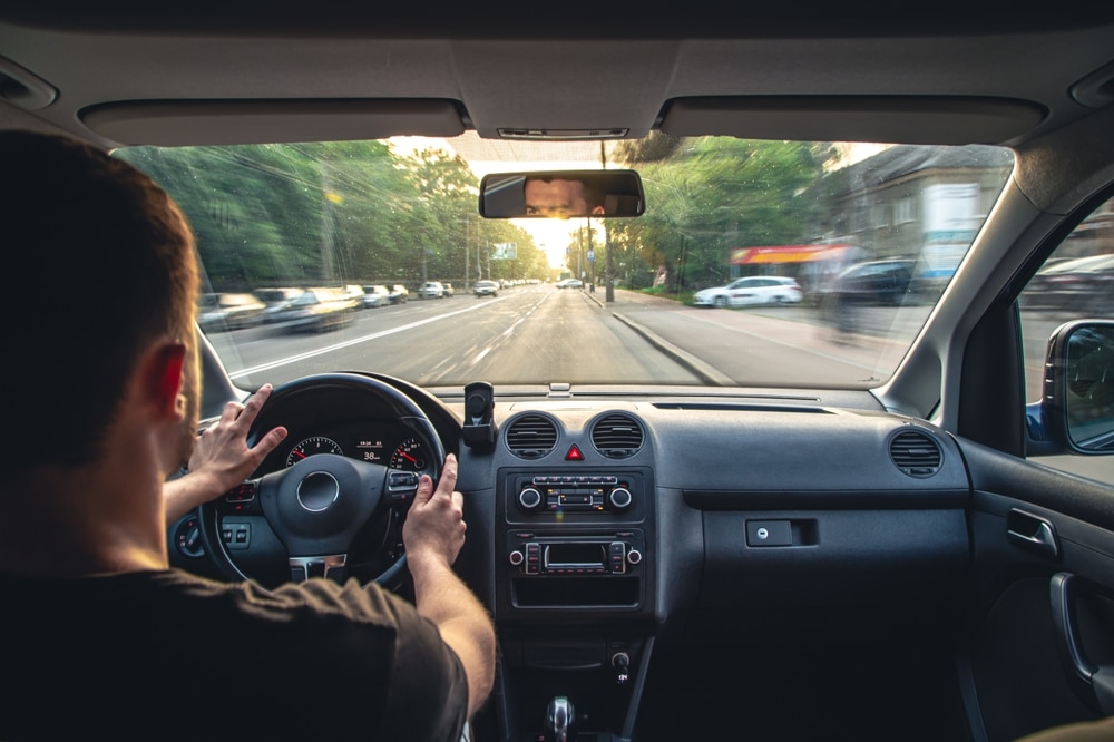 Hands on the wheel when driving at high speed from inside the car - auto glass repair new orleans